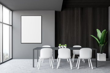 Gray and wooden dining room with poster