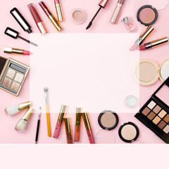 Background of woman cosmetics for social media on pink. Decorative cosmetics: highlighter, concealer, rouge, palette with eye shadows and brushes for face make up, face sculpture . Make up. Copy space