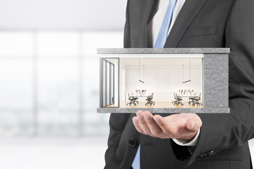 Architect holding modern office model