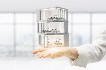 Architect holding business building model