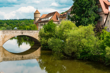 Fototapeta na wymiar Bridge, tower and houses along river Kocher. Schwabisch Hall, Germany 2