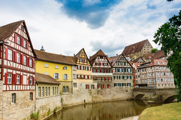 Fototapeta na wymiar Half timbered houses with red shutters along river Kocher in Schwabisch Hall, Germany