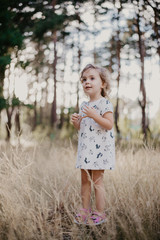 cute little girl in the sunny forest