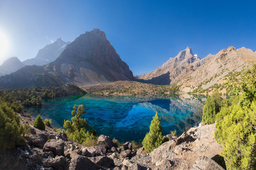 Fann mountains, Tajikistan. Amazing turquoise transparent water in lakes of Fan mountains. Scenery view on Alaudin lake in Pamir-Alay mountain range on sunny bright day.