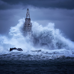 Big wave against old Lighthouse in the port of Ahtopol, Black Sea, Bulgaria on a moody stormy day....