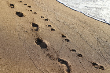 footprints in the sand on the shores of the Mediterranean Sea in the north of Israel