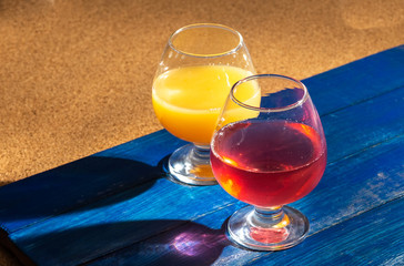 Glasses of fruit drinks are on the table.