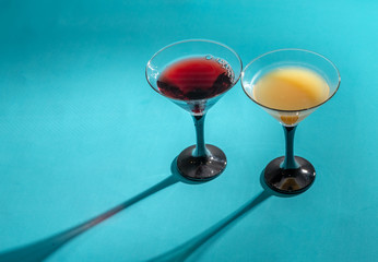 Glasses with fruit drinks on a turquoise .