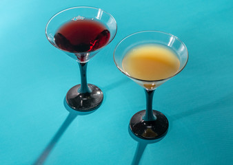 Glasses with fruit drinks on a turquoise .