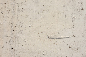 Light concrete surface with flaws