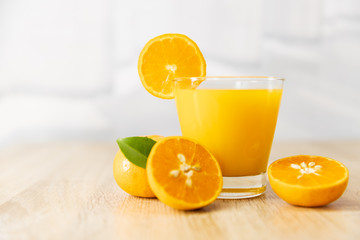 Orange juice on wooden table in the kitchen at home