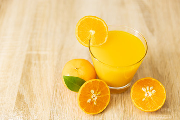 Orange juice on wooden table in the kitchen at home. Top view