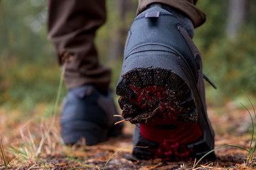 Close-ups of hiking shoes during a step in forest