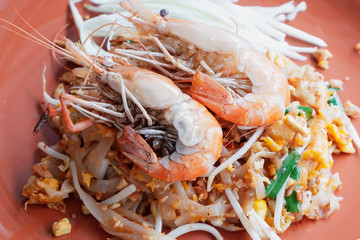 Pad Thai with fresh prawns in an orange plate