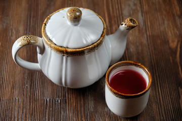Different tea in teapots on a dark wooden background. catering menu