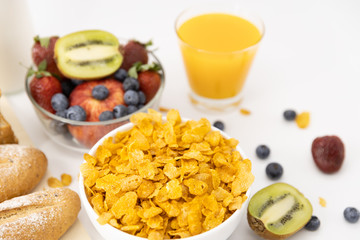 Healthy breakfast. bread, orange juice, strawberry, blueberries, kiwi, milk and cereal in bowl on white background. Healthy food