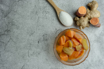Sweet Potato Orange in Ginger Syrup on cement background, Dessert. Top view