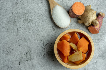 Sweet Potato Orange in Ginger Syrup on cement background, Dessert. Top view