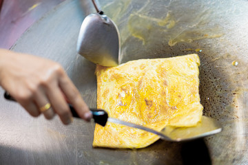 Thai street food-traditional Thai pancakes fried on a pancake close-up. with banana, chocolate, nut paste