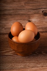 A carton of eggs on a wooden background