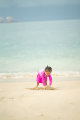 Little asian girl playing on the beach.Vacation and relax concept.