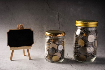 Savings concept: coins in jar with copy space for text
