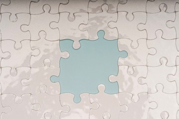 Closed up shot of blank white puzzle pieces, selective focus, copy space for text