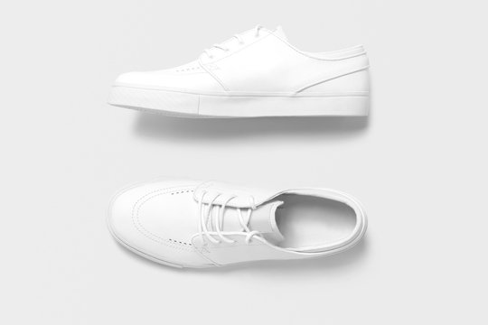Top and side view of white plain women men casual shoes on isolated background.