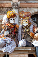 Venice Carnival characters in a colorful brown and gold Carnival costumes and masks Venice Italy