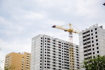 Construction of new house or building. General view. Unfinished cement building in the summer. The introduction of urbanization into nature. Capital construction in Ukraine