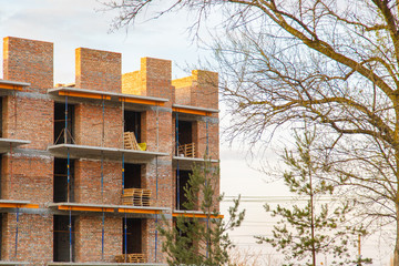 Construction of new house or building. General view. Unfinished cement building in the summer. The introduction of urbanization into nature. Capital construction in Ukraine