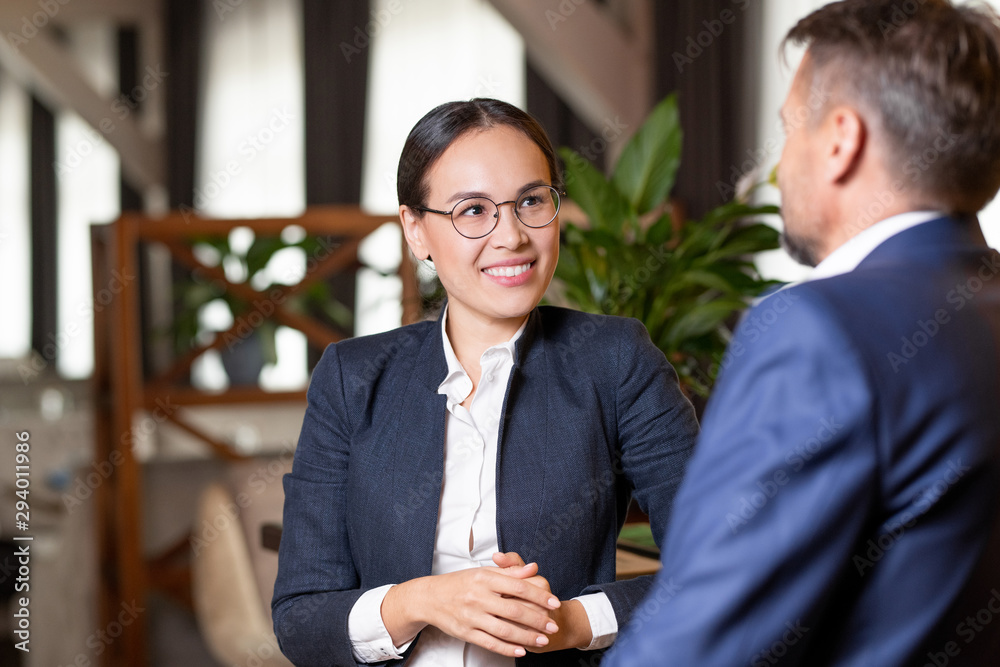 Canvas Prints pretty young cheerful agent in formalwear and eyeglasses talking to client