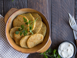 Crispy potato pancakes with green herbs and yogurt sauce. 