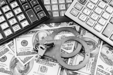 Financial fraud concept, calculators, handcuffs and money