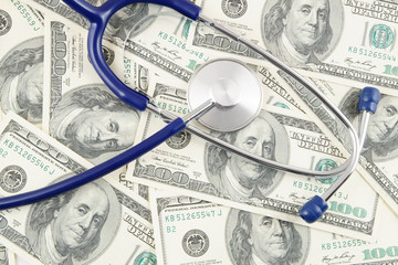 Stethoscope on dollar banknotes, cost of healthcare concept