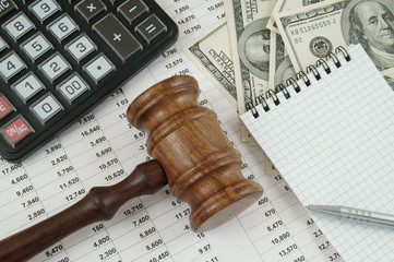Business concept with calculator, notebook, judge gavel, money, pen, notebook and documents 