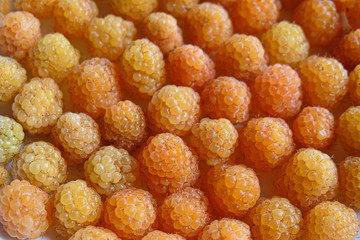  Background from ripe berries of  yellow raspberry. Top view. ....