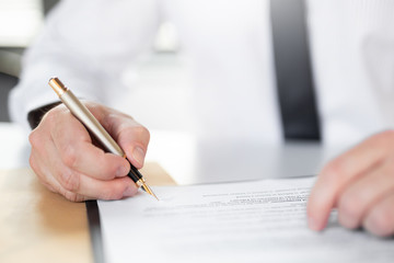 Business man signing contract, making a deal.