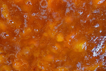 Natural texture of bright orange apricot jam. Homemade preparations for the winter-jam. The view from the top. Close up.