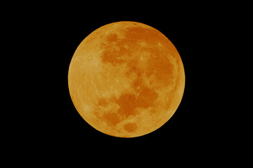 Bright orange full moon on night sky.