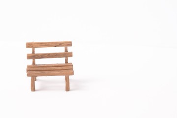 Fototapeta na wymiar Mini wooden bench isolated against white