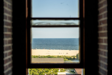 looking at the beach through the window