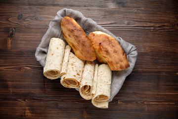 Pita bread of different types in a bread basket . restaurant menu