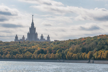 Moscow autumn. View at Moscow State University towering over the autumn forest and Moscow river. Moscow, Russia.