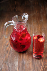 Different soft drinks in transparent jugs on a dark wooden background. menu for catering