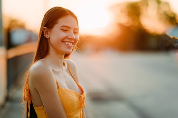 Portrait of a woman with loose long hair at sunset.
