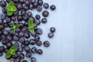 Blueberries on blue wooden background