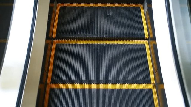 Escalator in motion, close up point of view, reversible and loopable