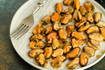 mussels in oil and spices (appetizer mollusks, pickled seafood, healthy food) menu concept. food background. copy space. Top view