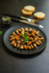 mussels in oil and spices (appetizer mollusks, pickled seafood, healthy food) menu concept. food background. copy space. Top view